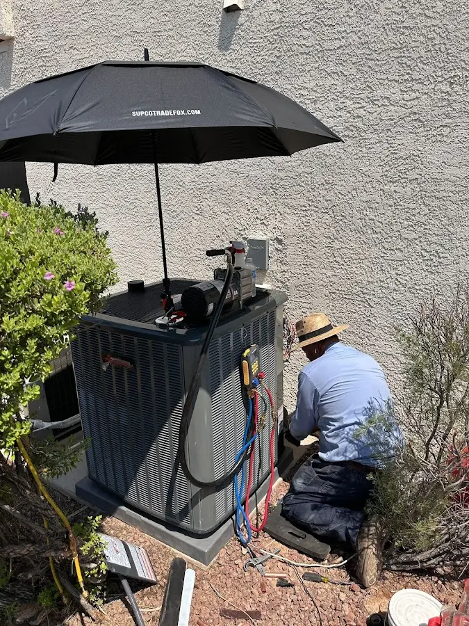 HVAC technician performing outdoor AC maintenance in Buenaventura Lakes