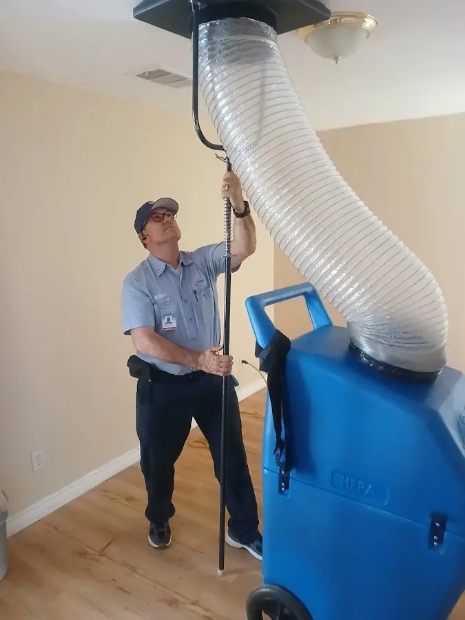 Furnace Tune-Up technician using HEPA equipment in Buenaventura Lakes